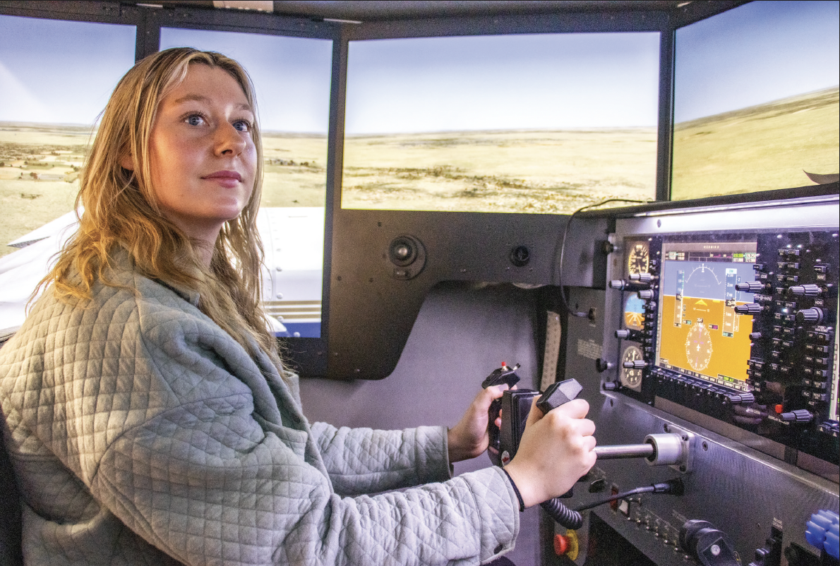 NW Aviation student Savannah Lejeune pilots a Redbird flight simulation, to practice taking off and landing an airplane.